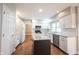 Bright kitchen featuring white cabinets, subway tile backsplash, stainless steel appliances, and wood floors at 9127 Pointe Ct, Fishers, IN 46037