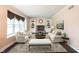 Cozy staged living room with built-in shelves, fireplace, plush seating, and colorful rug at 9127 Pointe Ct, Fishers, IN 46037