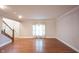 Spacious living room filled with natural light from large windows and hardwood floors at 9127 Pointe Ct, Fishers, IN 46037