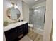 Updated bathroom with marble-look shower, navy vanity, and stylish gold finishes at 9277 Embers Way, Indianapolis, IN 46250