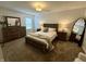 Cozy bedroom with neutral tones, a wooden dresser, and a plush bed with ample natural light at 9277 Embers Way, Indianapolis, IN 46250