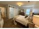 Well-lit bedroom features a wooden dresser, sliding door closet, and neutral décor at 9277 Embers Way, Indianapolis, IN 46250