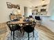 Charming dining area with seating for four, with views into the modern kitchen at 9277 Embers Way, Indianapolis, IN 46250