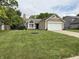 Charming one-story home boasts manicured lawn, stone accents, and an attached two-car garage at 9277 Embers Way, Indianapolis, IN 46250