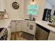 Well-lit modern kitchen featuring white cabinetry, stainless steel appliances, and stone countertops at 9277 Embers Way, Indianapolis, IN 46250