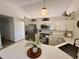 Modern kitchen featuring stainless steel appliances, white cabinets, and stone countertops, with modern lighting at 9277 Embers Way, Indianapolis, IN 46250