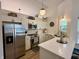 Modern kitchen featuring stainless steel appliances, white cabinets, and stone countertops, with modern lighting at 9277 Embers Way, Indianapolis, IN 46250