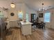 Bright kitchen features white cabinets, quartz countertops, and eat-in area with modern light fixtures at 9277 Embers Way, Indianapolis, IN 46250