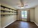 Cozy bedroom featuring tile floors, a ceiling fan, built-in shelving, and a bright window with curtains at 948 Kitner Ave, Avon, IN 46123
