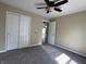 Carpeted bedroom with a ceiling fan and closet offers ample space and natural light at 948 Kitner Ave, Avon, IN 46123