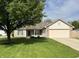 Charming single-story home with well-manicured lawn and attached two-car garage at 948 Kitner Ave, Avon, IN 46123
