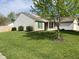Well-maintained home showcasing a lush green lawn and mature shade tree at 948 Kitner Ave, Avon, IN 46123