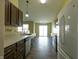 Well-lit kitchen boasts stainless steel appliances, dark cabinetry, and tile floors leading to sliding glass doors at 948 Kitner Ave, Avon, IN 46123