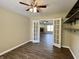 Versatile room with ceiling fan and shelving leads through French doors to living room with fireplace at 948 Kitner Ave, Avon, IN 46123
