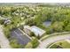 Overhead shot of community pool, tennis courts, clubhouse, and surrounding suburban neighborhood at 10144 Water Crest Dr, Fishers, IN 46038