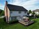 The backyard features a large deck with seating and an umbrella, plus a swing set on lush green grass at 10144 Water Crest Dr, Fishers, IN 46038