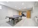Finished basement with a ping pong table and sliding barn doors leading to a home gym at 10144 Water Crest Dr, Fishers, IN 46038