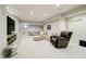 Spacious finished basement with a sectional sofa, TV, and a separate ping pong area at 10144 Water Crest Dr, Fishers, IN 46038