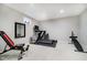 Home gym in a finished basement with a treadmill, weight bench, and full length mirror at 10144 Water Crest Dr, Fishers, IN 46038