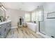 Luxurious bathroom with a freestanding tub, a glass-enclosed shower, and double vanity sinks at 10144 Water Crest Dr, Fishers, IN 46038