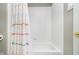 Clean and modern bathtub with a decorative shower curtain in a well-maintained bathroom at 10144 Water Crest Dr, Fishers, IN 46038