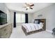 Cozy bedroom featuring a ceiling fan, a window with curtains, and a full bed with built in shelving and drawers at 10144 Water Crest Dr, Fishers, IN 46038