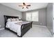 Bright bedroom featuring a ceiling fan, window, and a comfortable queen bed with a throw at 10144 Water Crest Dr, Fishers, IN 46038