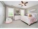 Bright bedroom with a white bed, dresser, and cheerful decor, creating a cozy and inviting space at 10144 Water Crest Dr, Fishers, IN 46038
