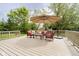 A spacious deck with outdoor seating, an umbrella, and views of the green backyard at 10144 Water Crest Dr, Fishers, IN 46038
