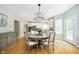 Dining area featuring a chandelier, round table, and views of the kitchen with stainless steel appliances at 10144 Water Crest Dr, Fishers, IN 46038