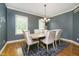 Dining room with wood table, upholstered chairs, elegant chandelier, and natural light from windows at 10144 Water Crest Dr, Fishers, IN 46038