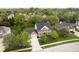Aerial view of a two-story brick home with a well-maintained lawn, mature trees, and an attached garage at 10144 Water Crest Dr, Fishers, IN 46038