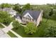 Aerial view of a brick two-story home with a well-manicured lawn, mature trees and an attached garage at 10144 Water Crest Dr, Fishers, IN 46038
