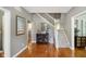 Inviting foyer with hardwood floors, staircase, decorative mirror, and view into other rooms at 10144 Water Crest Dr, Fishers, IN 46038