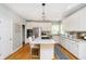 Modern kitchen with white cabinets, granite countertops, stainless steel appliances, and an island with seating at 10144 Water Crest Dr, Fishers, IN 46038