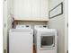 Convenient laundry room equipped with a washer, dryer, and overhead cabinets for storage at 10144 Water Crest Dr, Fishers, IN 46038