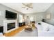 Comfortable living room with a fireplace, hardwood floors, and ample natural light from the windows at 10144 Water Crest Dr, Fishers, IN 46038
