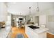 Open living space features hardwood floors, a dining area, and a kitchen island with a cooktop at 10144 Water Crest Dr, Fishers, IN 46038