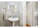 Charming powder room features a pedestal sink, decorative mirror, and neutral paint at 10144 Water Crest Dr, Fishers, IN 46038