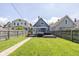 Backyard featuring a spacious deck with grill, a well maintained lawn and privacy fence at 1132 Evison St, Indianapolis, IN 46203