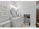 Modern bathroom with a double vanity, stylish mirrors, and a well-organized built-in shelf with storage at 1132 Evison St, Indianapolis, IN 46203