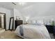 Bright bedroom featuring a large bed, black dresser, a standing mirror and stylish decor at 1132 Evison St, Indianapolis, IN 46203