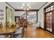 Cozy dining room featuring hardwood floors, classic trim, and a view into the spacious living room at 1132 Evison St, Indianapolis, IN 46203
