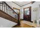 Warm entryway featuring hardwood floors, an original front door, and a stained glass window accent at 1132 Evison St, Indianapolis, IN 46203