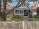 Charming two-story home with a cozy front porch, well-kept landscaping, and a classic picket fence at 1132 Evison St, Indianapolis, IN 46203