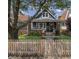 Charming two-story home with a picket fence and inviting front porch with rocking chairs at 1132 Evison St, Indianapolis, IN 46203