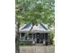 Charming blue two-story home with brick accents, a covered porch, and a white picket fence at 1132 Evison St, Indianapolis, IN 46203