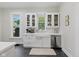 Bright white kitchen with modern appliances, a farm sink, marble countertops, and tile flooring at 1132 Evison St, Indianapolis, IN 46203