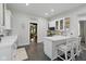 Well-lit kitchen with a breakfast bar, modern appliances, white cabinets, and tile flooring at 1132 Evison St, Indianapolis, IN 46203