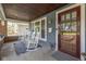 Inviting front porch with rocking chairs, a blue rug, and craftsman architectural details at 1132 Evison St, Indianapolis, IN 46203